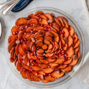 overhead shot of sweet potato rose in a pie dish next to a blue spoon rest