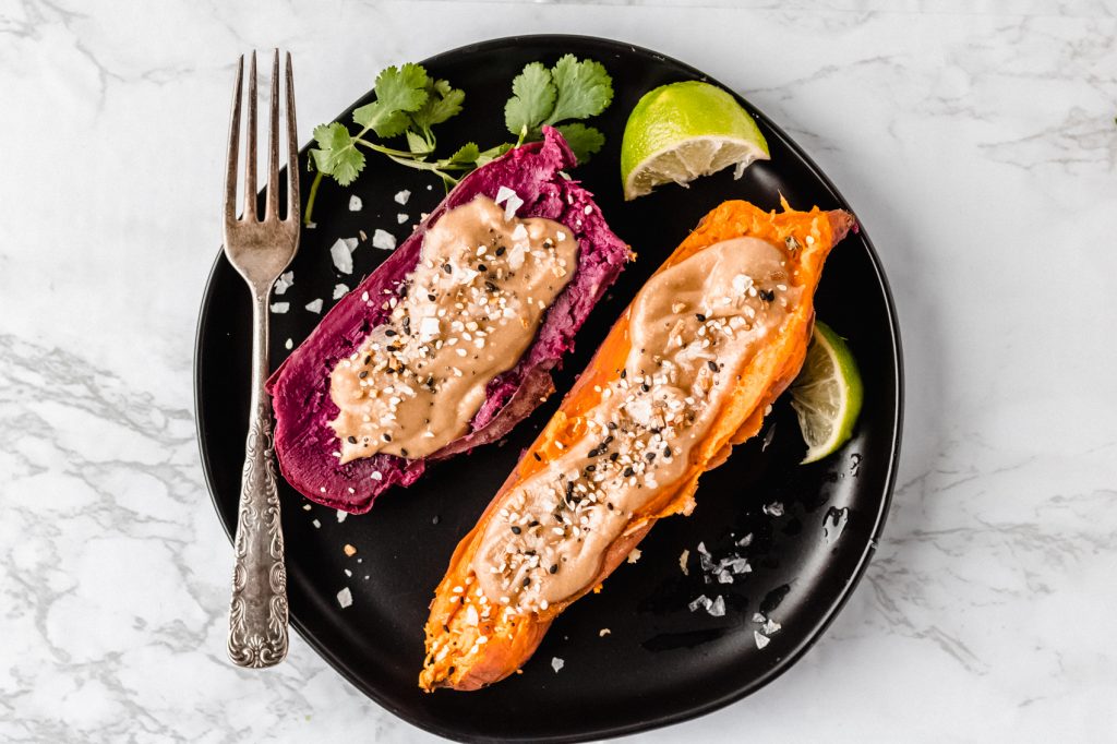 one purple and one orange sweet potato with tahini butter