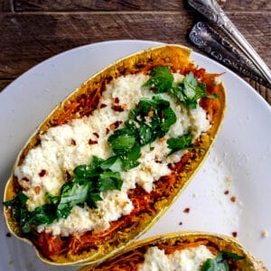 overhead shot of spaghetti squash lasagna boat on a white plate