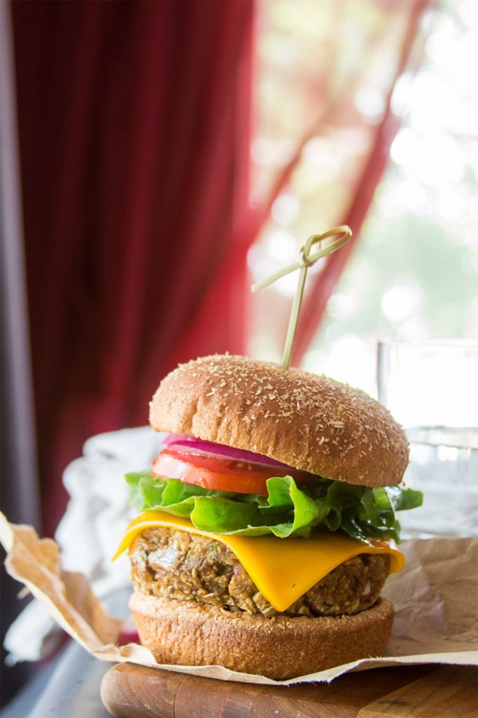 burger on paper in front of red curtain