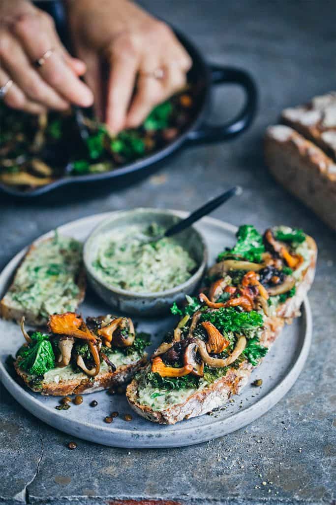 white plate with sourdough toast with mushrooms and lentils