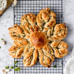 star bread stuffed with herbs on a wire rack