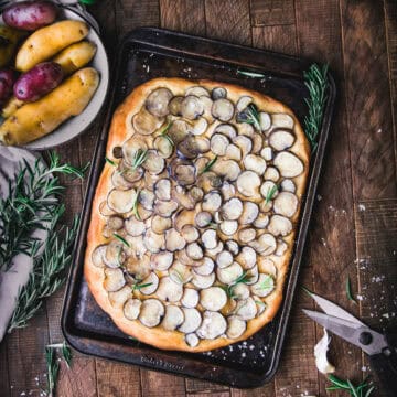 overhead shot of rosemary potato focaccia on a sheet tray