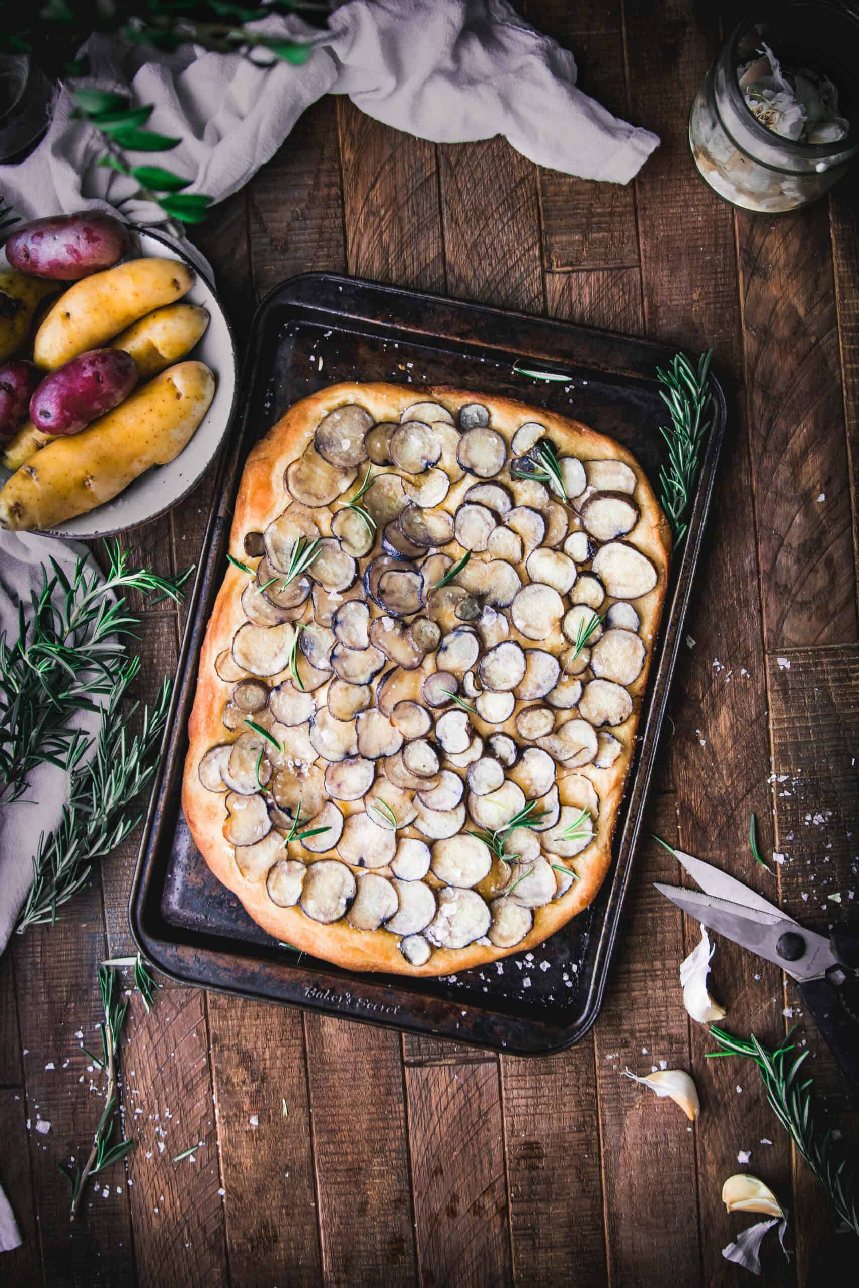 overhead shot of rosemary potato focaccia on a sheet tray