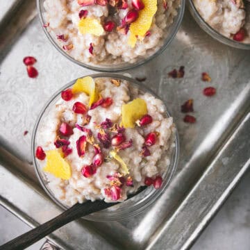 close up shot of vegan sushi rice pudding with pomegranate and rose petals