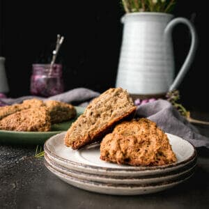 plate of two vegan scones next to a jar pf jam