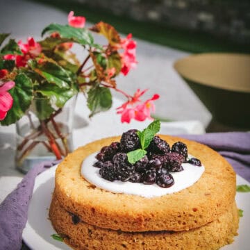 side view of a vegan olive oil cake with berries