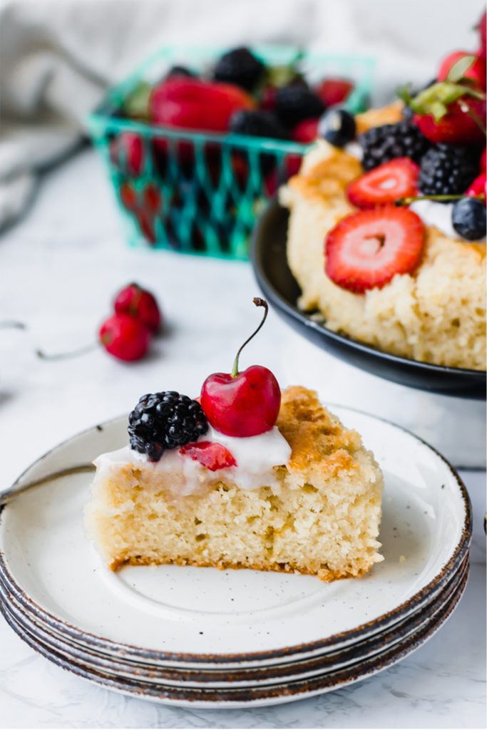 slice of olive oil cake with berries on top