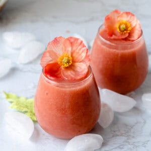 two glasses of frose with orange flowers