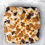 birds eye view of brownies topped with toasted marshmallows and graham cracker pieces
