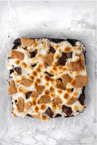 birds eye view of brownies topped with toasted marshmallows and graham cracker pieces