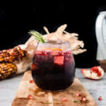 glass of red sangria on a wooden board