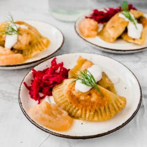 plate of vegan pierogi next to beet kraut