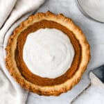 overhead shot of vegan pumpkin pie topped with coconut whipped cream