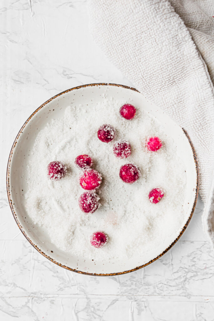 sugared cranberries on a white plate shot from overhead