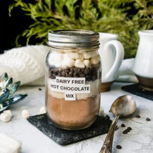 mason jar filled with vegan hot cocoa mix, topped with chocolate chips and marshmallows