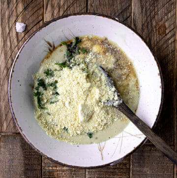 overhead shot of tahini salad dressing with wooden spoon