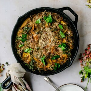 overhead shot of french onion skillet pasta bake on a marble board with a silver spoon