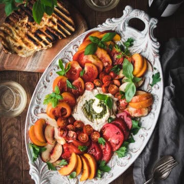 grilled flatbread next to an heirloom tomato and peach summer salad