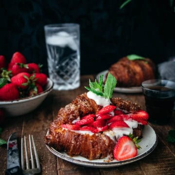 crispy golden baked croissant with strawberries and mint