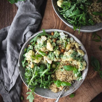 ovehead shot of cauliflower quinoa bowl with arugula