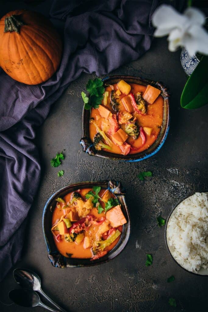 two bowls of pumpkin curry shot from overhead