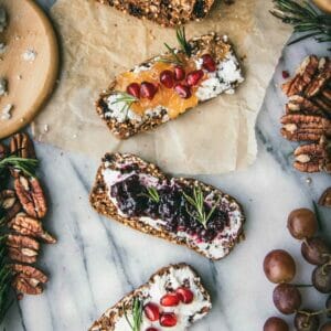 line of three gourmet crackers on a marble cheese plate