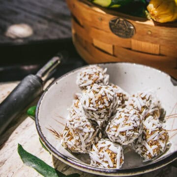 bowl of no bake zucchini bread bites next to a basket of zucchini