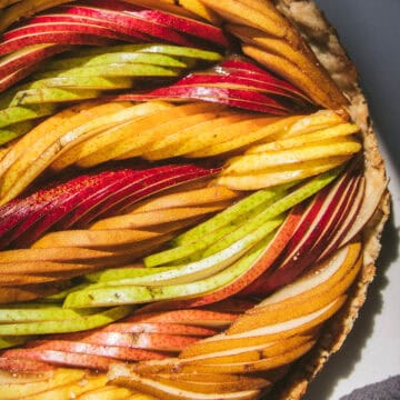 close up of a woven fresh pear tart