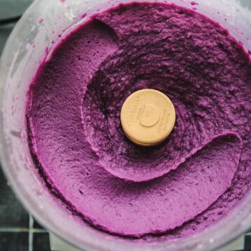 food processor with an overhead shot of whipped purple sweet potatoes