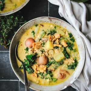 overhead view of a bowl of vegan pesto zuppa toscana