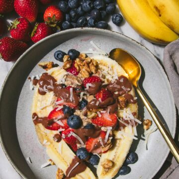 banana split overnight oats next to fresh fruit