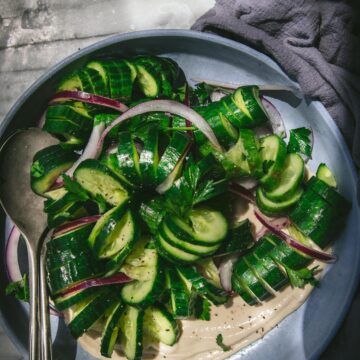 overhead shot of a bowl of spiraled sesame cucumber salad