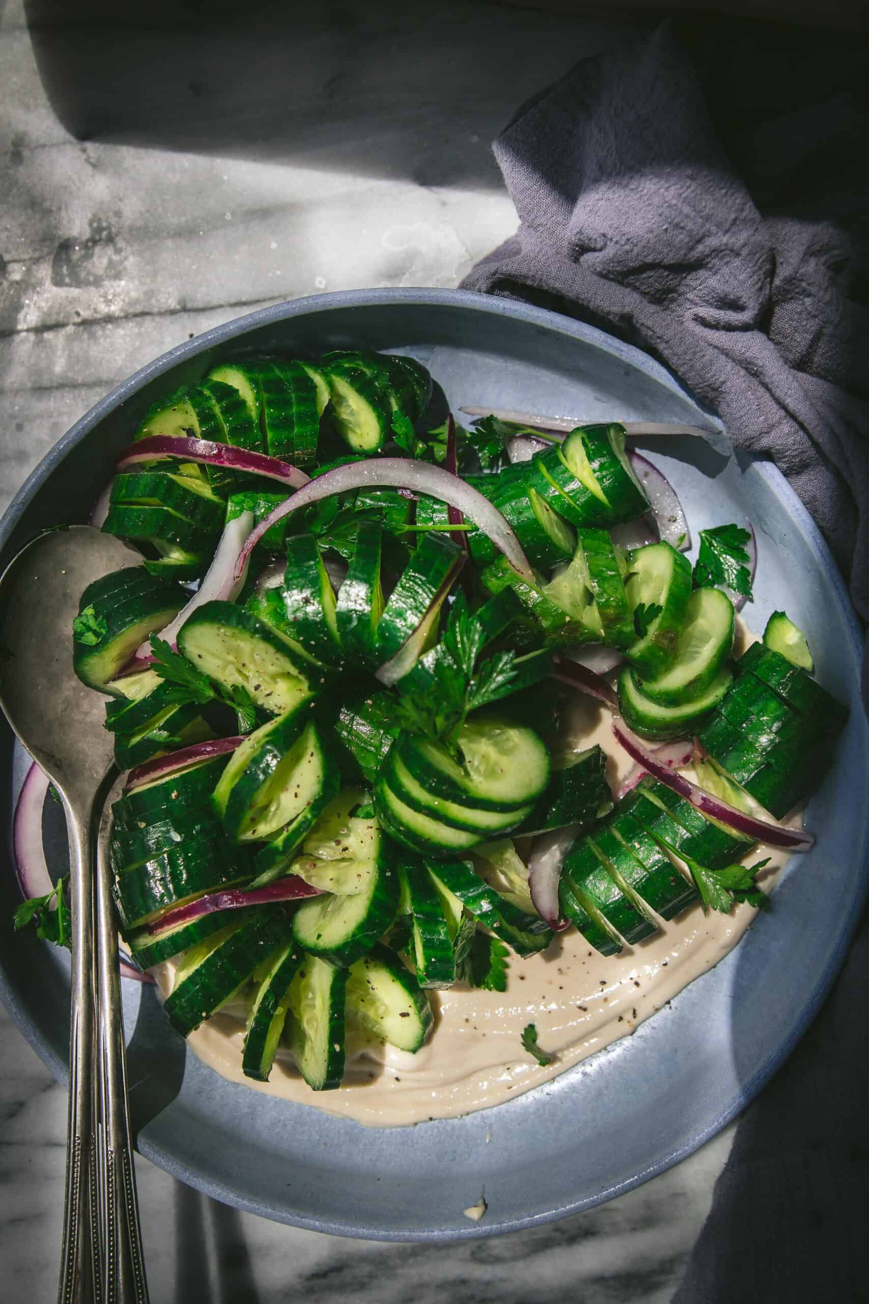 overhead shot of a bowl of spiraled sesame cucumber salad