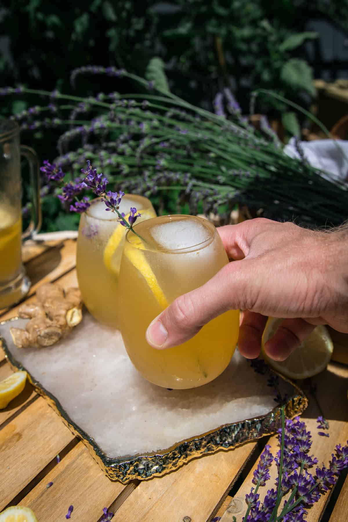 hand grabbing a glass of lavender ginger lemonade