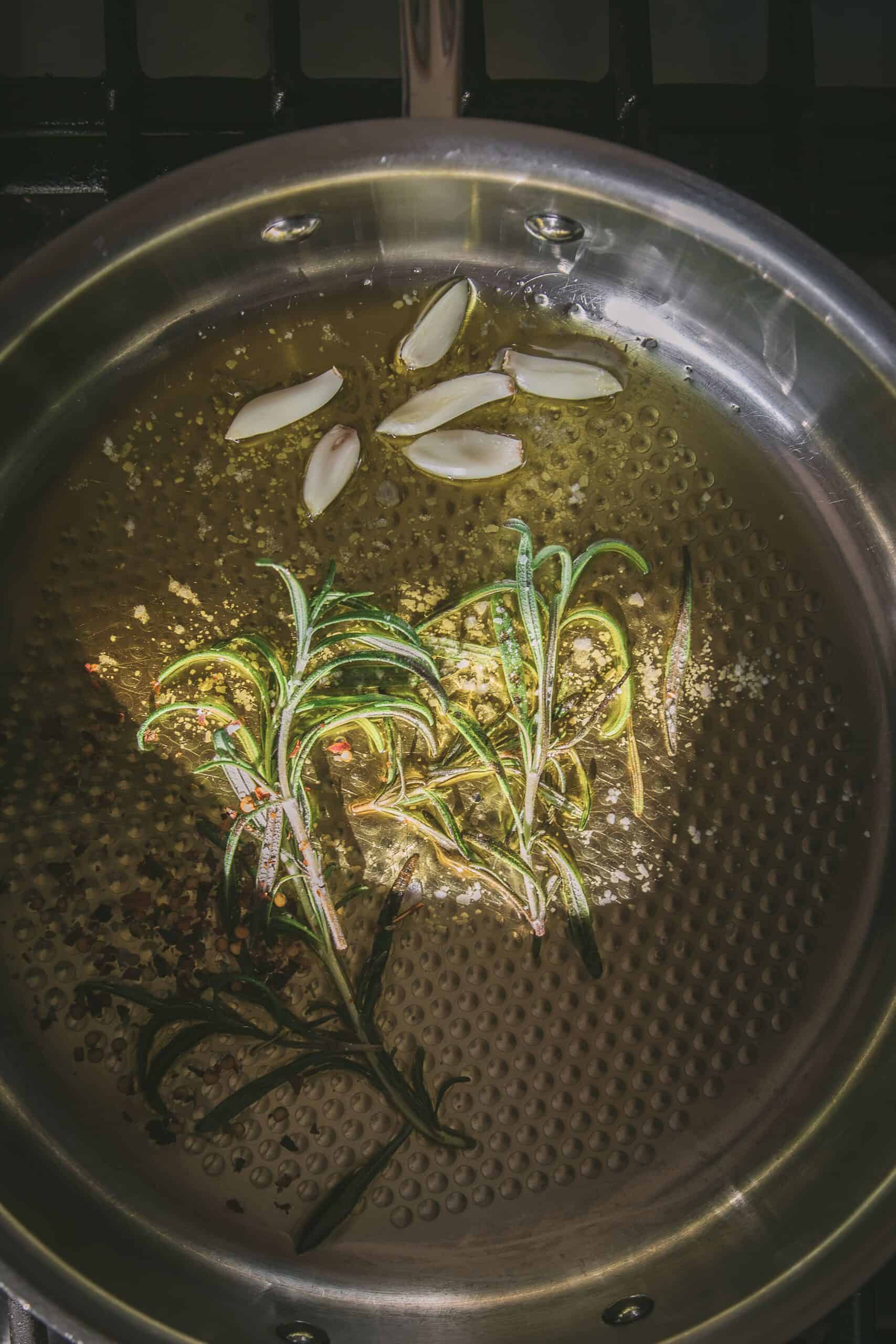 garlic and rosemary with olive oil in a skillet