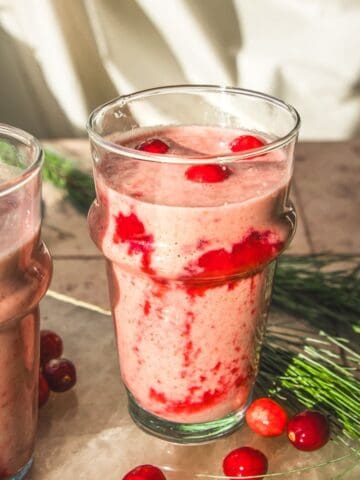 two vegan cranberry orange smoothies